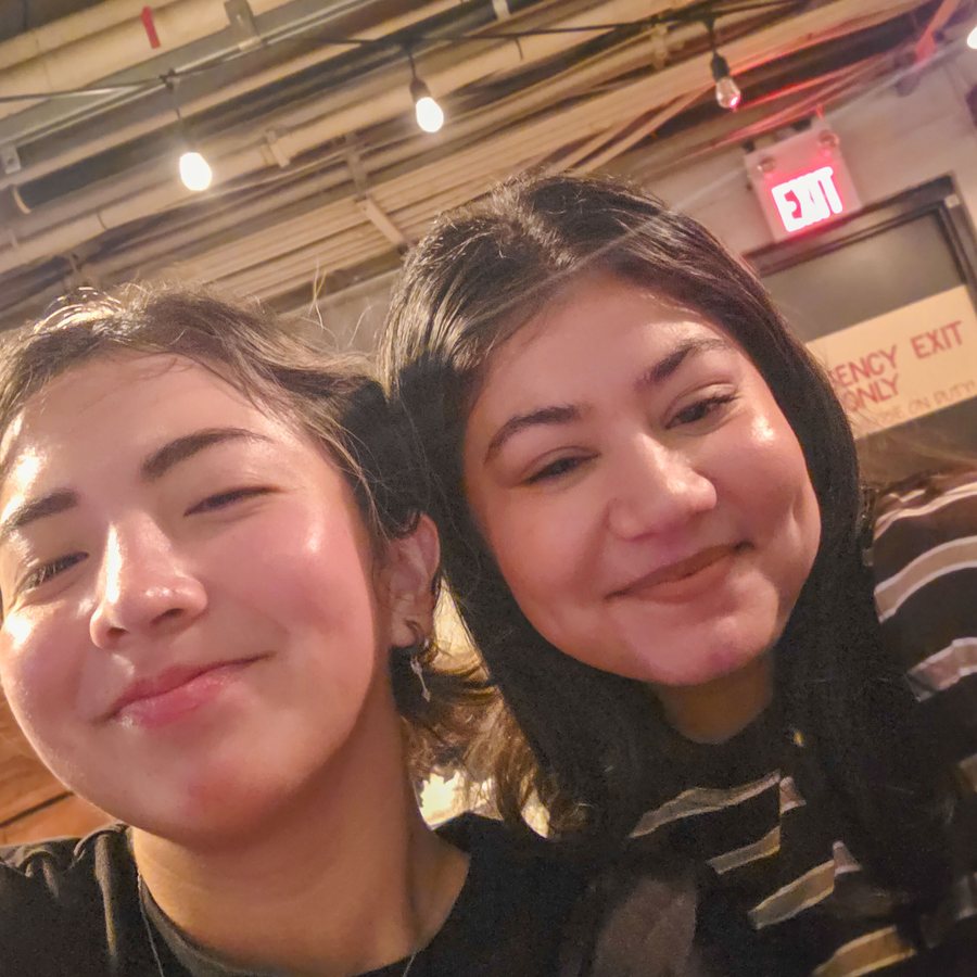 Two friends taking a selfie at a watch party